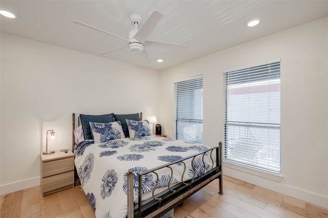 Bedroom with recessed lighting, light wood finished floors, and a ceiling fan | Image 12