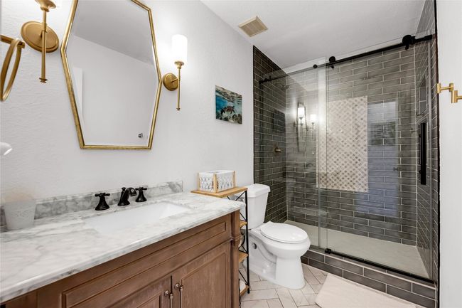 Full bath with vanity, toilet, tile patterned floors, a stall shower | Image 22