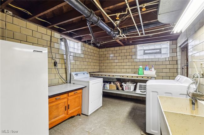 Laundry area with separate washer and dryer, a sink, and laundry area | Image 26