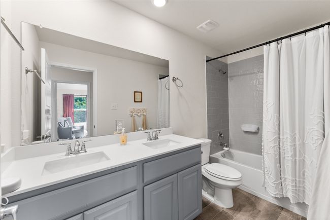 Bathroom with double vanity, shower / bath combination with curtain, and wood finished floors | Image 22