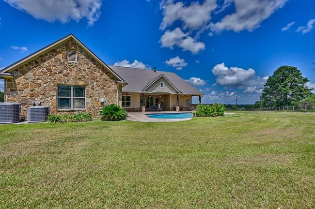 Charming home with a spacious backyard and inviting pool, perfect for relaxation and entertaining. | Image 40
