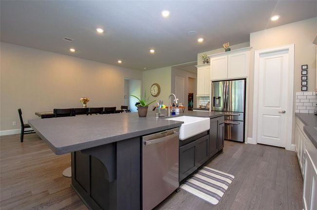 Another view of the kitchen with a walk in pantry. | Image 11