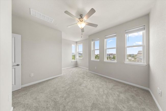 Carpeted spare room with a ceiling fan and baseboards | Image 20
