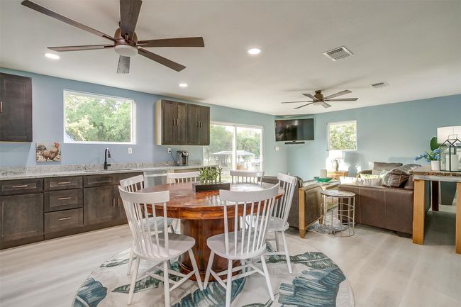 Dining space with visible vents, light wood finished floors, and ceiling fan | Image 16