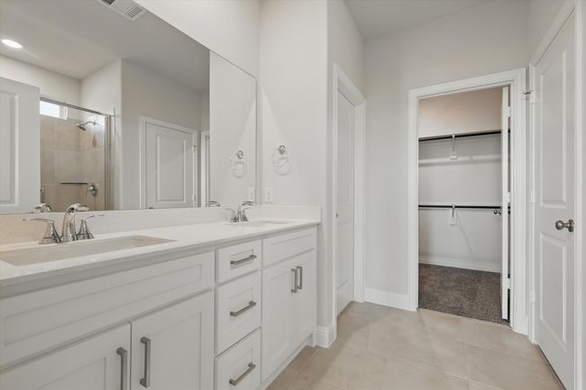 Bathroom, a sink, a stall shower, and tile patterned flooring | Image 11