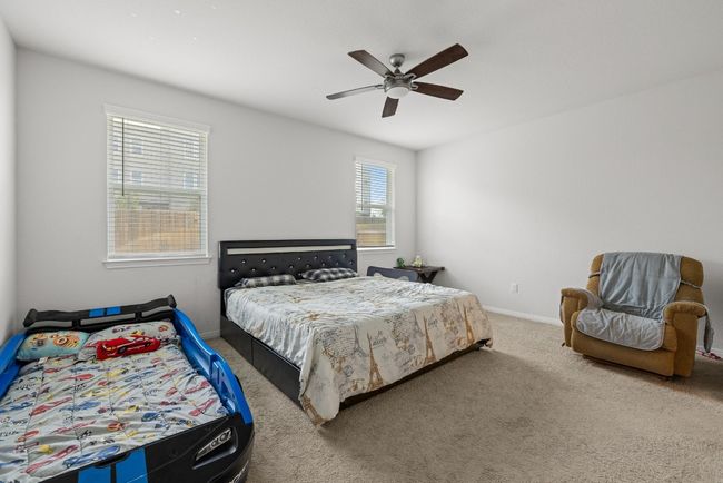 Carpeted bedroom with baseboards and a ceiling fan | Image 14