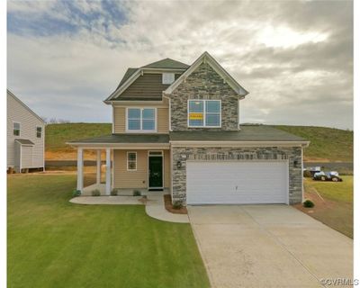 The Whitlock features 4 bedrooms, 3.5 baths and a front-load garage. Durable EVP flooring throughout the first floor main living areas. Architectural details including wainscoting and crown molding give the space a polished look. | Image 1