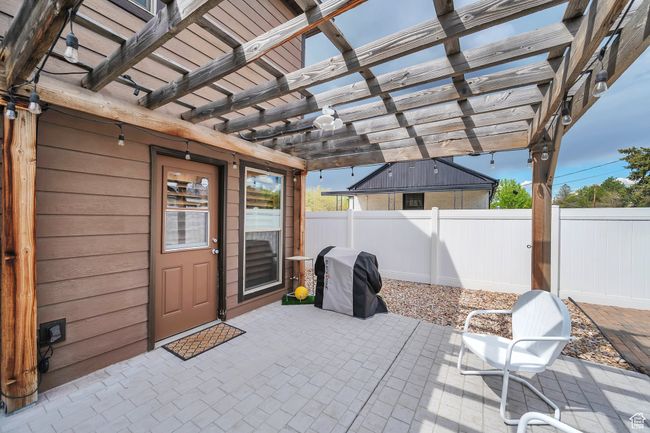 View of patio / terrace with a pergola, a grill, and fence | Image 20