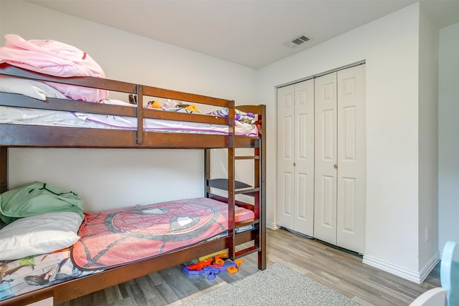 Bedroom featuring vinyl floors and a closet | Image 24