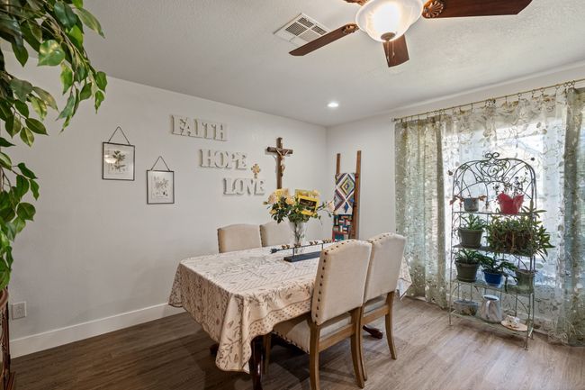 Dining space with wood finished floors, ceiling fan, and recessed lighting | Image 12