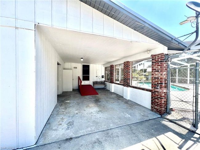 Carport and entrance to storage room/workshop. | Image 8