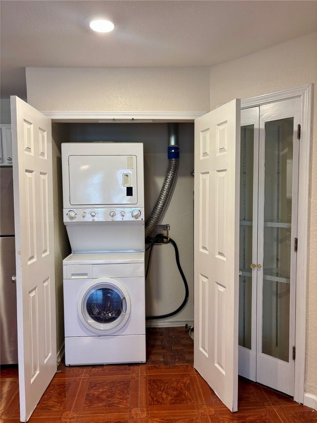 Laundry room with stacked washer and dryer and recessed lighting | Image 16