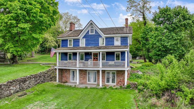 View of front of property with french doors, a front lawn, brick siding, and a chimney | Image 14