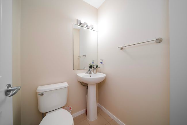 Bathroom with tile patterned floors, baseboards, a sink, and toilet | Image 22
