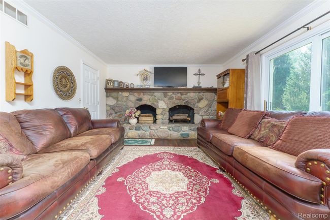 family room with natural fireplace | Image 15