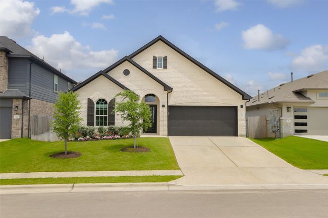 Brick exterior and covered front entry add timeless charm. | Image 26