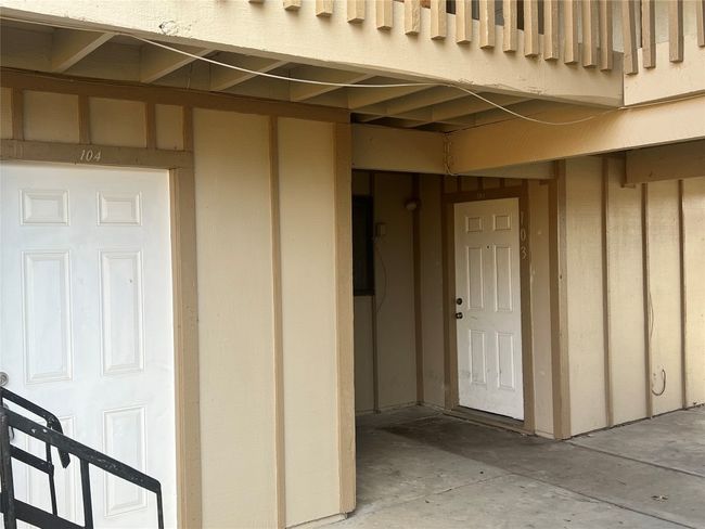 Property entrance featuring board and batten siding | Image 18