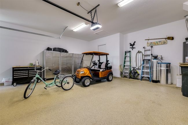 Garage with a garage door opener and baseboards | Image 21