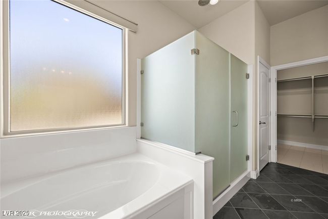 Bathroom with a shower stall, a garden tub, tile patterned flooring, and a walk in closet | Image 45