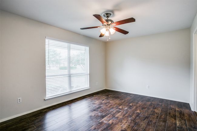 Empty room with ceiling fan and wood finished floors | Image 6