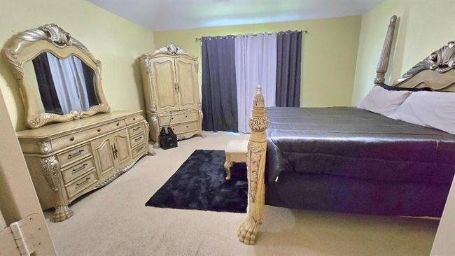 Master bedroom has a spacious layout and a bright ensuite bath connected with double doors. | Image 9