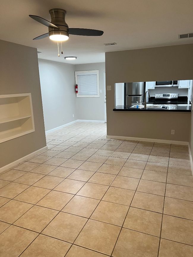 Spare room with light tile patterned floors, a ceiling fan, and visible vents | Image 10