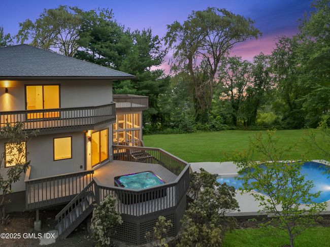 This is a partial view of the total of 9 decks the home has to offer. Hot tub seen from Prim Bedrm private deck | Image 31