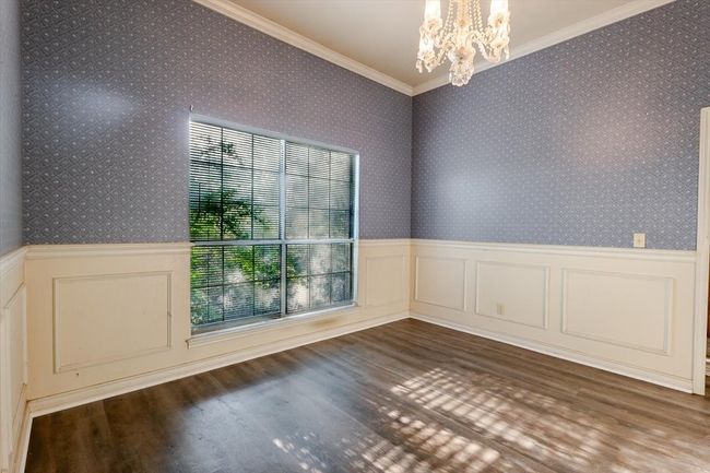 Beautiful dining room with beautiful wallpaper, wainscoting and custom chandelier. | Image 5