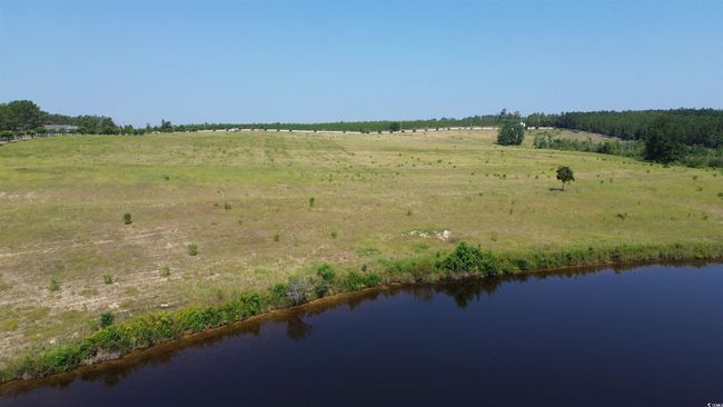 View of rural area featuring a nearby body of water | Image 9