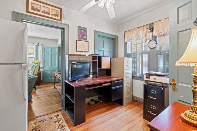 Office with a ceiling fan and light wood finished floors | Image 22