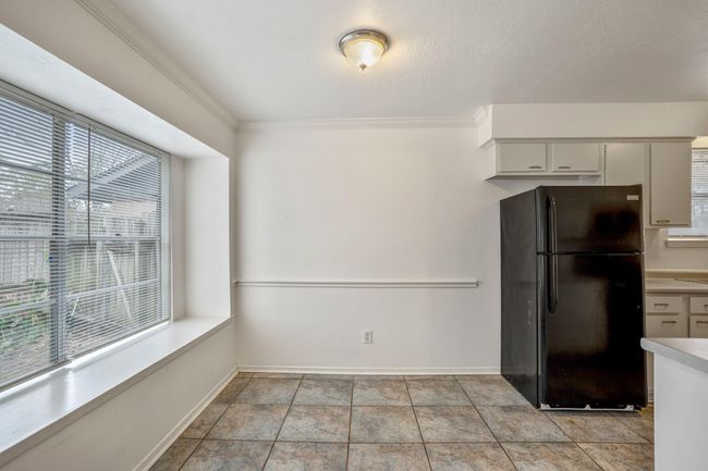 Stunning window lighting up the entire kitchen and even provides additional seating | Image 6
