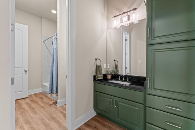 Full bath featuring baseboards, wood finished floors, vanity, and a shower with curtain | Image 33