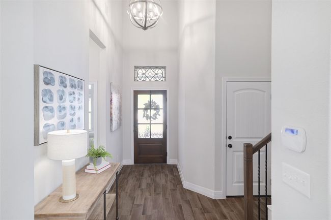 Foyer featuring a towering ceiling, an inviting chandelier | Image 9