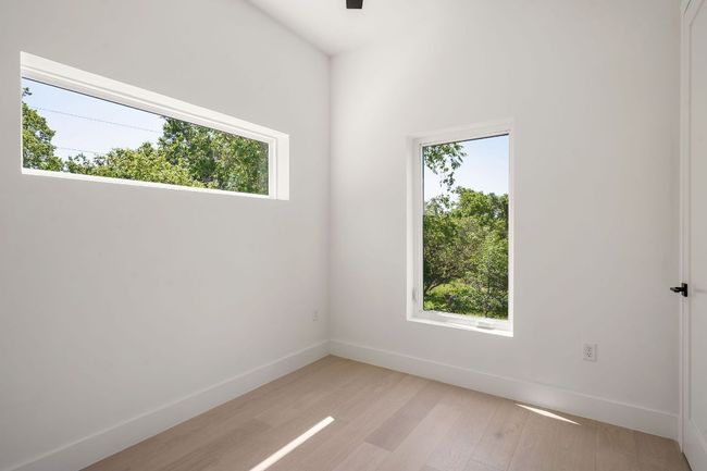 Spare room with baseboards and light wood finished floors | Image 15
