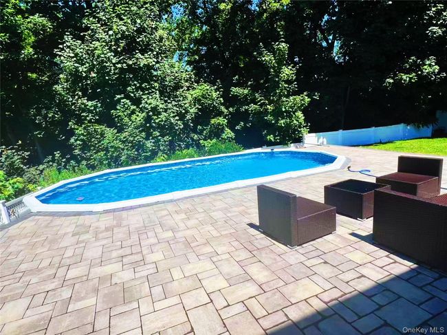 Outdoor pool featuring a patio area and an outdoor hangout area | Image 4