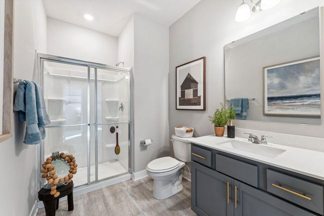 You'll find two baths on the main floor. This 3/4 bath is adjacent to the 5th bedroom. What a perfect suite for visitors! Photo of model home, colors and finishes will vary. | Image 18