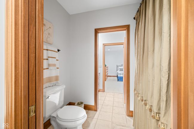 bathroom with tile patterned floors, baseboards, and toilet | Image 88