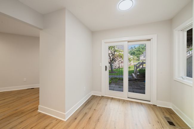 The kitchen nook with a slider to the front patio is perfect for a cafe or bistro sized table. | Image 6