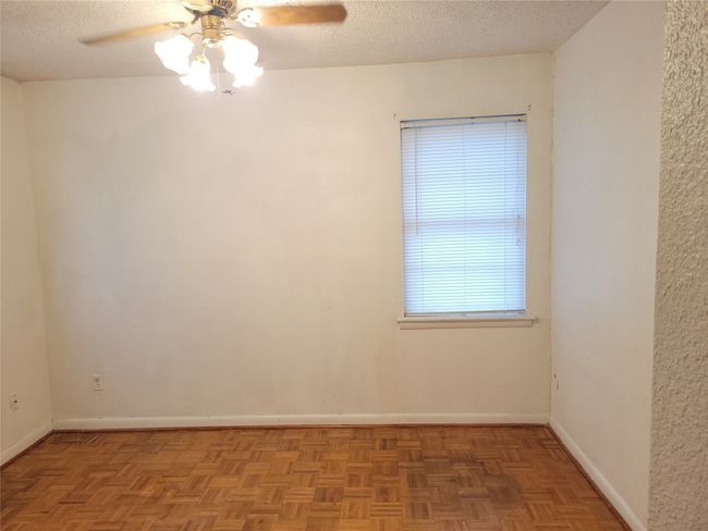 Spare room with ceiling fan, baseboards, and a textured ceiling | Image 9