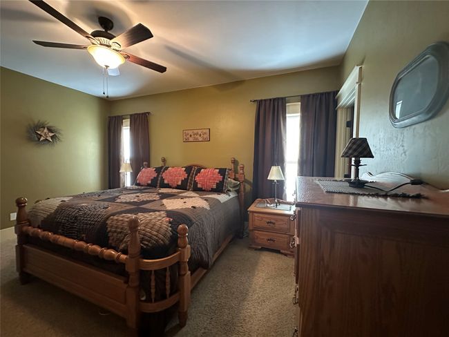 Bedroom with carpet floors and ceiling fan | Image 11