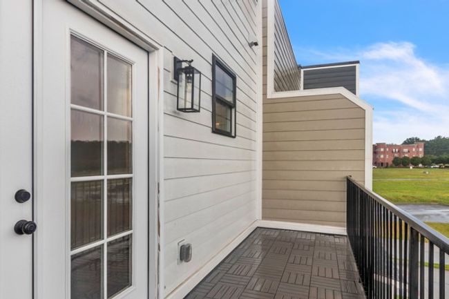French doors lead to a large private deck for guests and family to enjoy. Notice the additional window to add more natural light to the guest bath. | Image 22