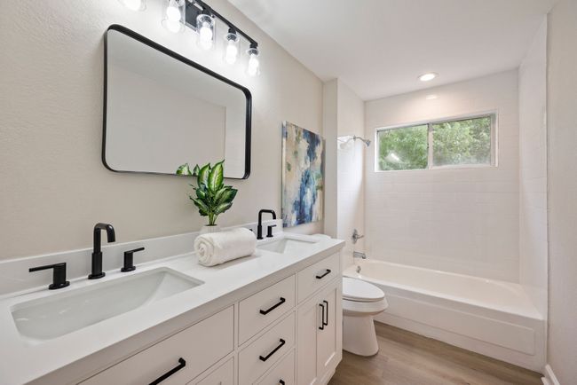 Updated full bathroom with a dual sinks, black fixtures, and clean white finishes. It’s bright and functional, ideal for family or guests. | Image 31