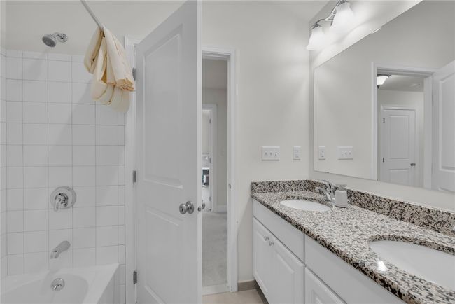 Full bath featuring double vanity and bathtub / shower combination | Image 13