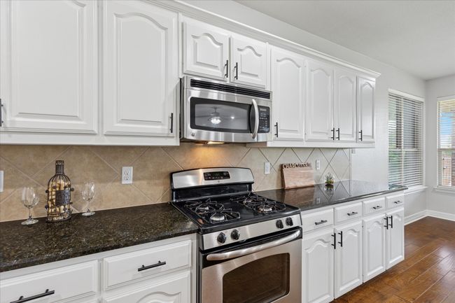 Kitchen with stainless steel appliances, granite counter tops, gas cook top | Image 11