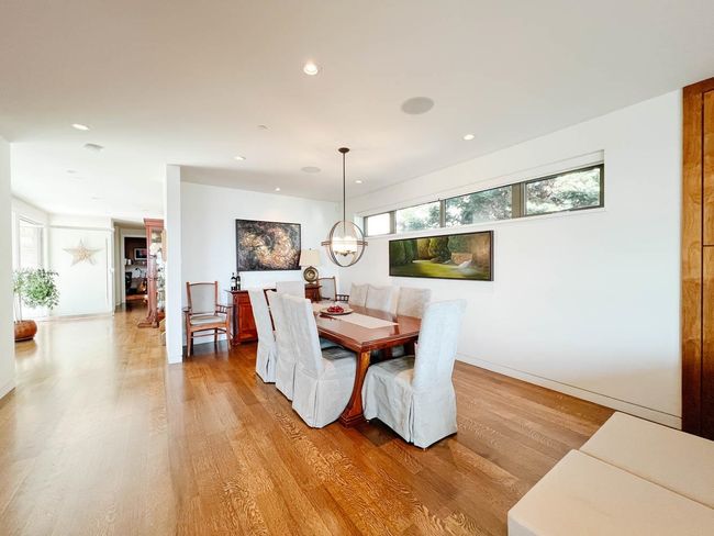 Dining area with light wood finished floors, plenty of natural light, recessed lighting, a chandelier, and baseboards | Image 9