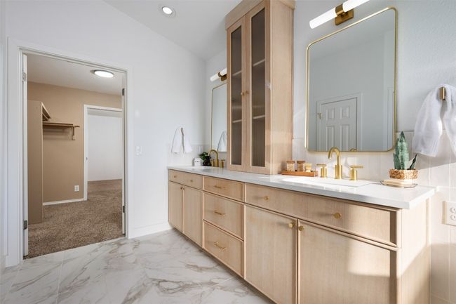 Bathroom featuring vanity, recessed lighting, marble finish floor, lofted ceiling, and baseboards | Image 28