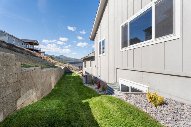 View of grassy yard featuring cooling unit and a mountain view | Image 9
