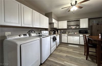 Kitchen in Unit A with a Laundry area. | Image 3