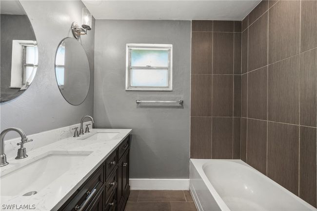 Bathroom featuring tile patterned floors and dual bowl vanity | Image 35
