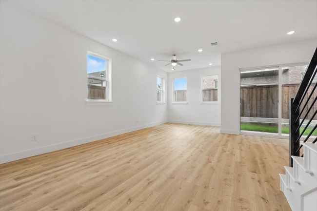 Unfurnished living room featuring stairs, a ceiling fan, recessed lighting, light wood-style flooring, and baseboards | Image 10